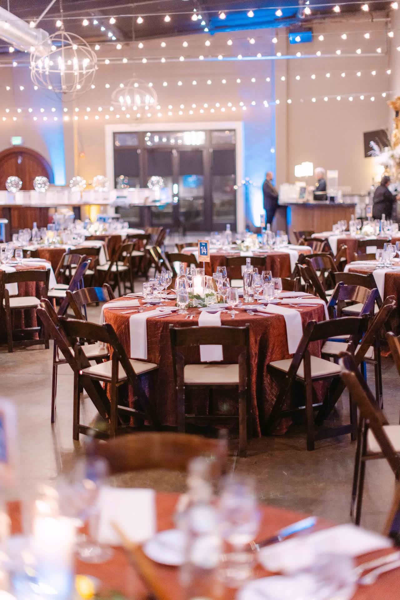 Corporate gala tables arranged under warm event lighting