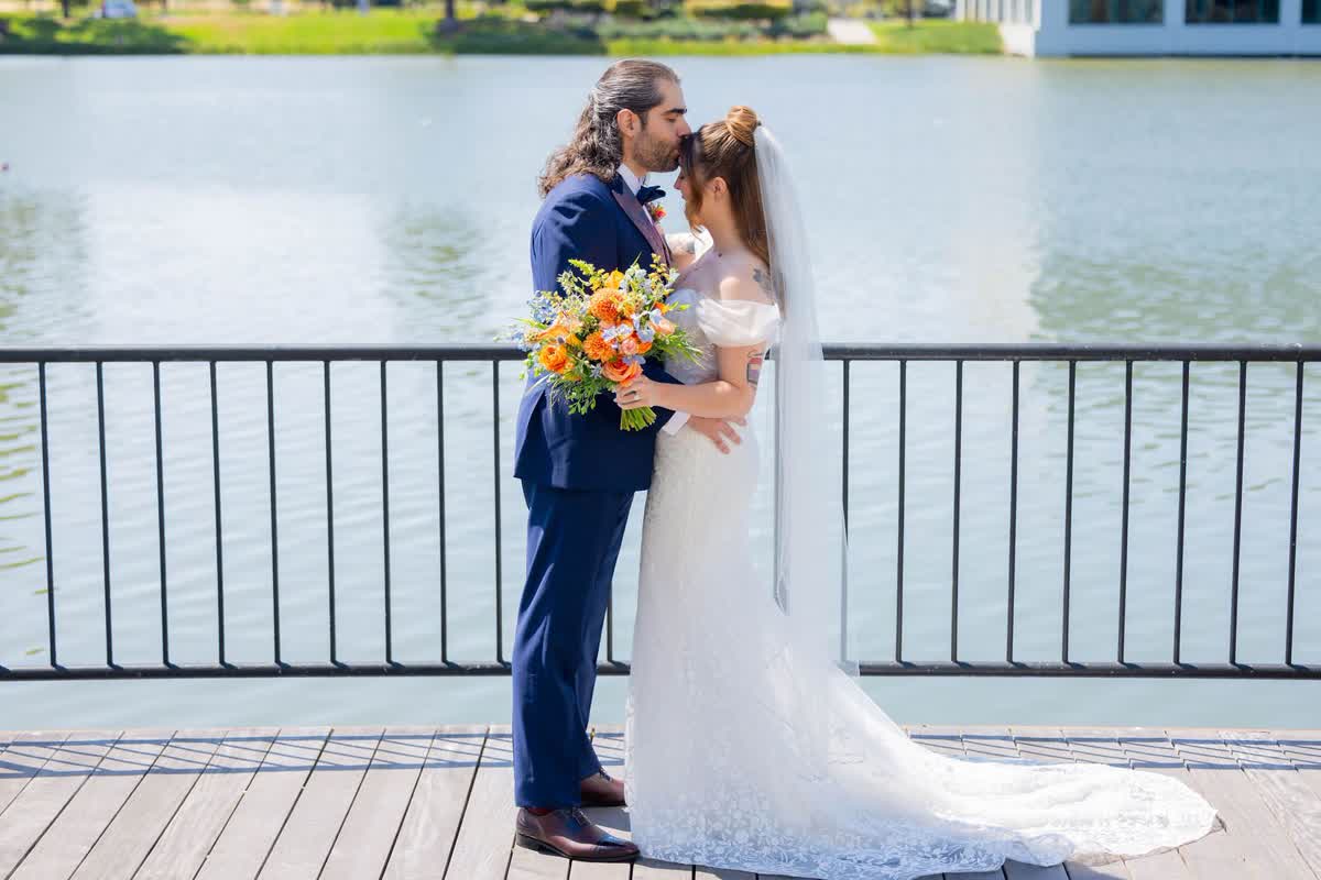 Bride and groom portrait beside the water