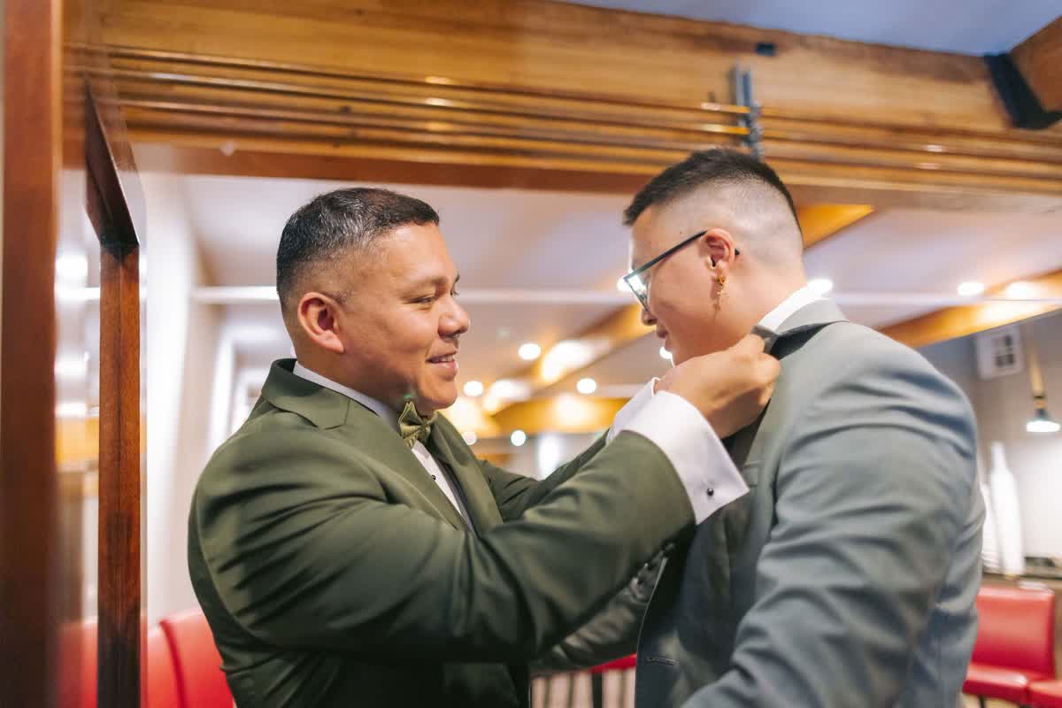 Groom receiving help with final wedding details