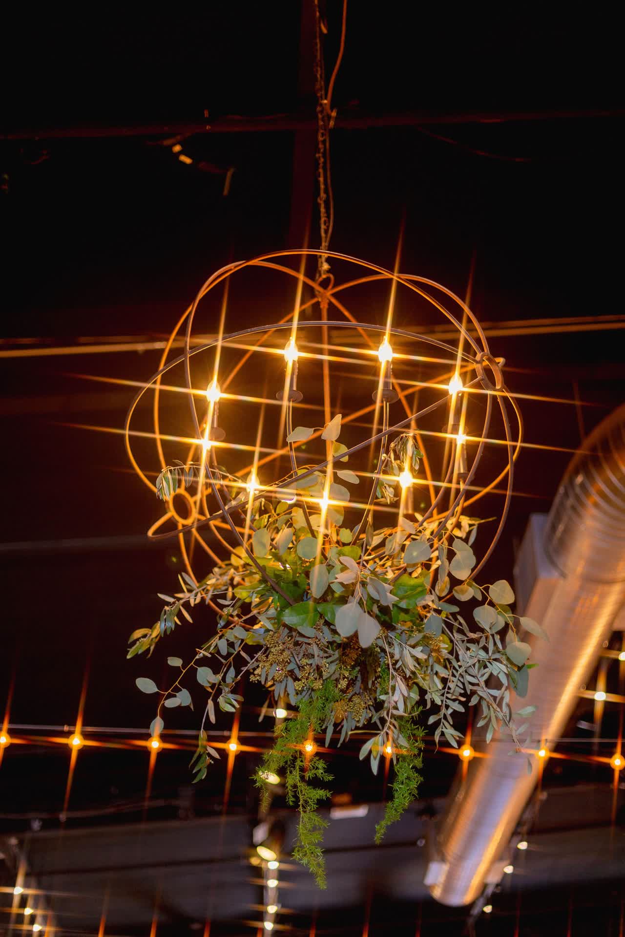 Hanging floral installation with warm reception lighting